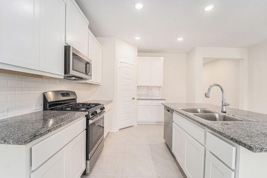 Lots of cabinets, beautiful gray granite counter tops and white subway tile backsplash Lots of cabinets, beautiful gray granite counter tops and white subway tile backsplash