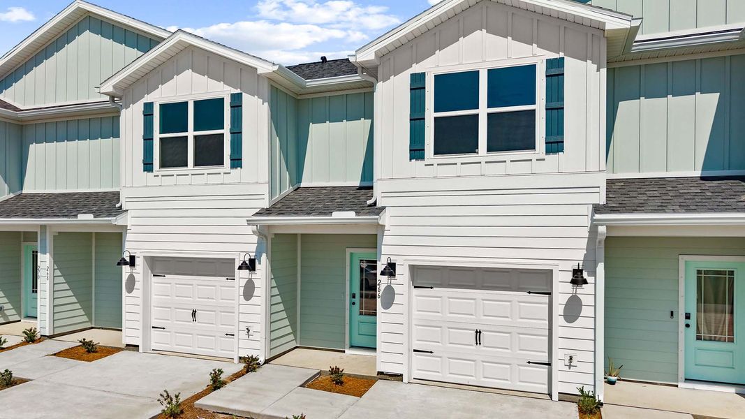 Front exterior of a new home in Colonial East Townhomes, Panama City Beach, FL, highlighting curb appeal (Image 1). Front exterior of a new home in Colonial East Townhomes, Panama City Beach, FL, highlighting curb appeal (Image 1).