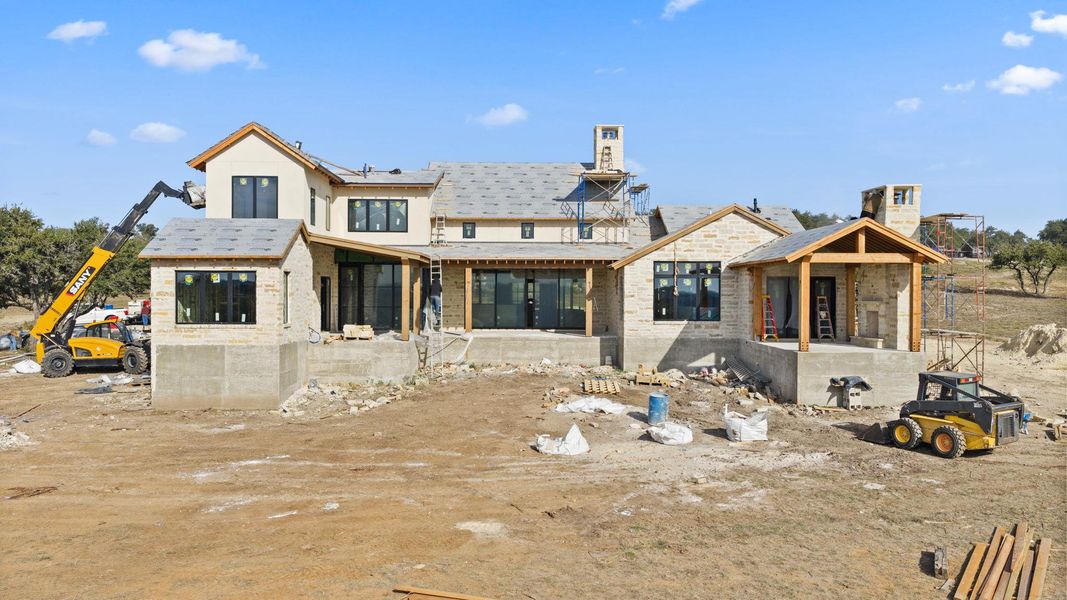 Back of property featuring stone siding Back of property featuring stone siding