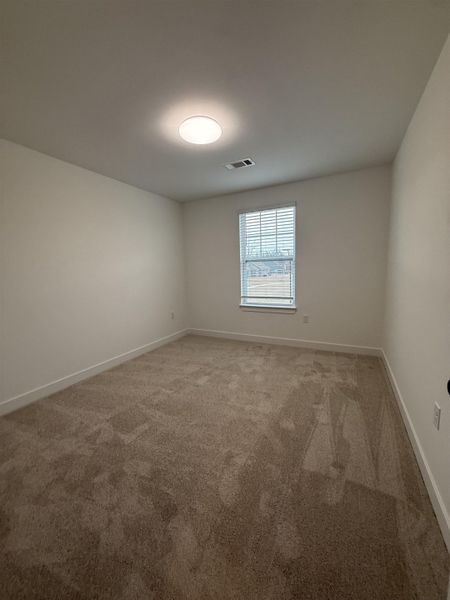 Unfurnished room featuring light colored carpet and baseboards