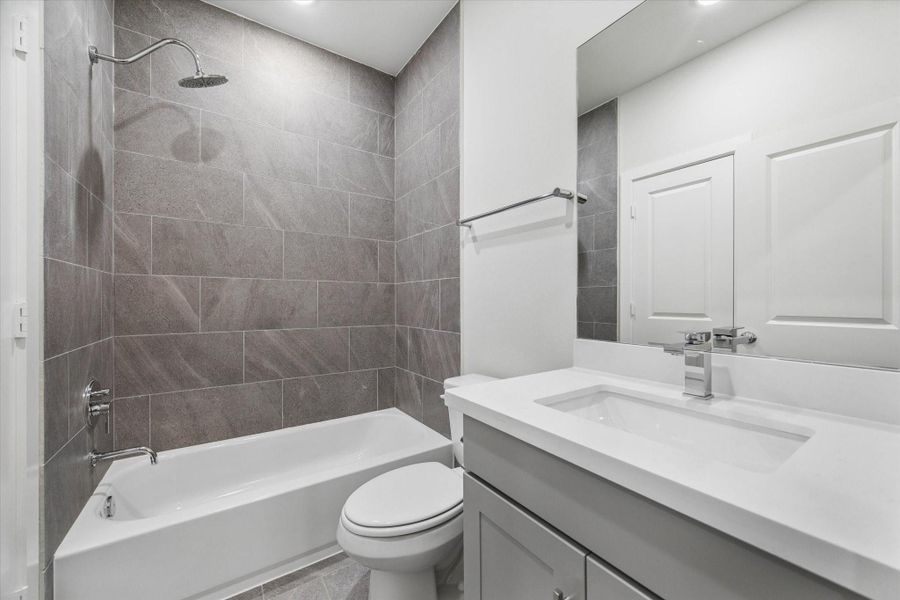 secondary bathroom that belongs to the 3rd bdrm on the third level. quartz counters, chrome finishes, porcelian tiles. secondary bathroom that belongs to the 3rd bdrm on the third level. quartz counters, chrome finishes, porcelian tiles.