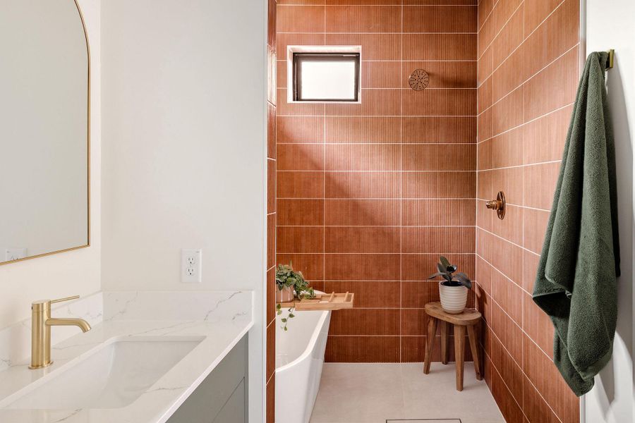 Full bath featuring vanity, a tile shower, tile patterned floors, and a bathtub Full bath featuring vanity, a tile shower, tile patterned floors, and a bathtub