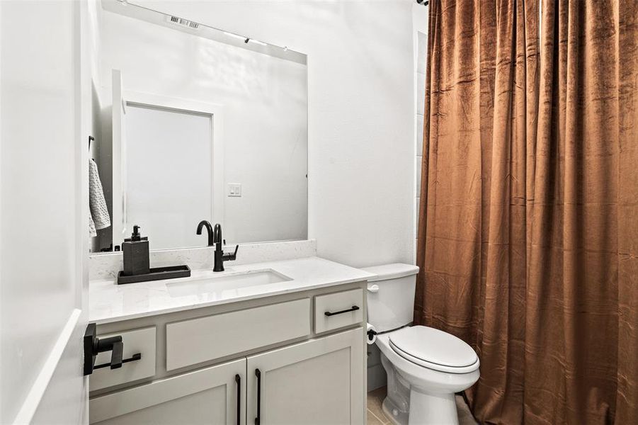 Full bath featuring curtained shower and vanity Full bath featuring curtained shower and vanity
