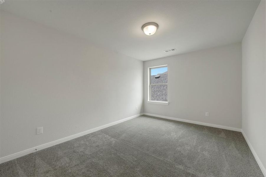 Room featuring light gray walls, gray carpet flooring, white baseboards, and a single window with white trim