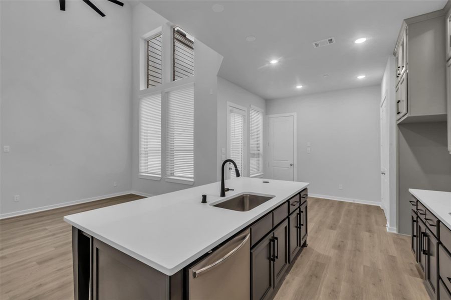 Kitchen overlooks the family room and dining area, creating an open, connected space.