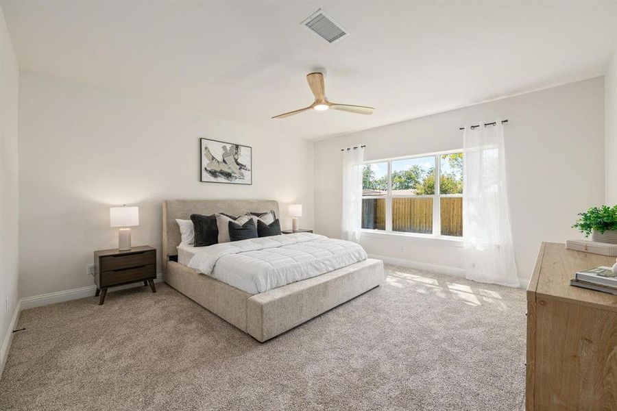 Carpeted bedroom with a ceiling fan and baseboards Carpeted bedroom with a ceiling fan and baseboards