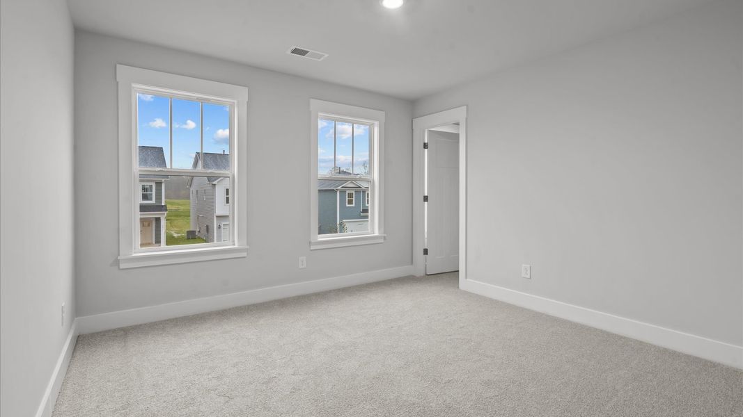 Memorable space with walk-in closet, soft carpeting, and striking natural light from large windows Memorable space with walk-in closet, soft carpeting, and striking natural light from large windows