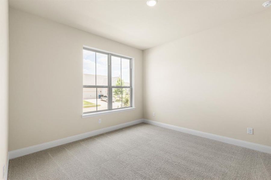 Unfurnished room featuring light colored carpet