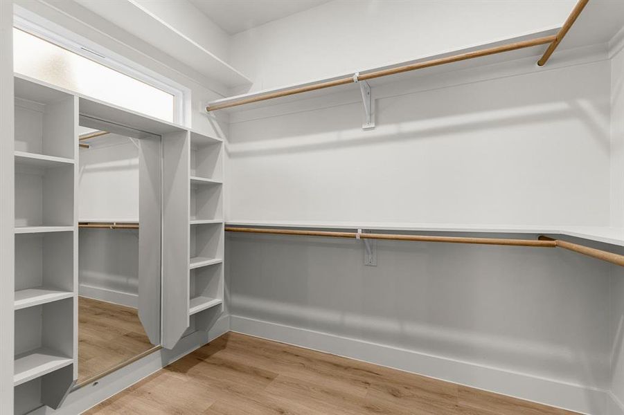 Spacious closet with hardwood / wood-style floors