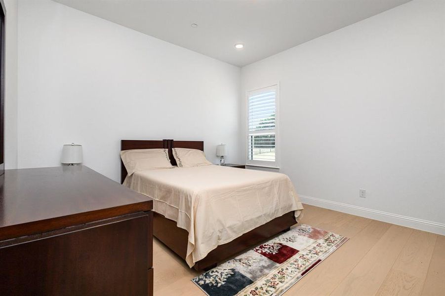 Bedroom with light wood-style flooring and recessed lighting