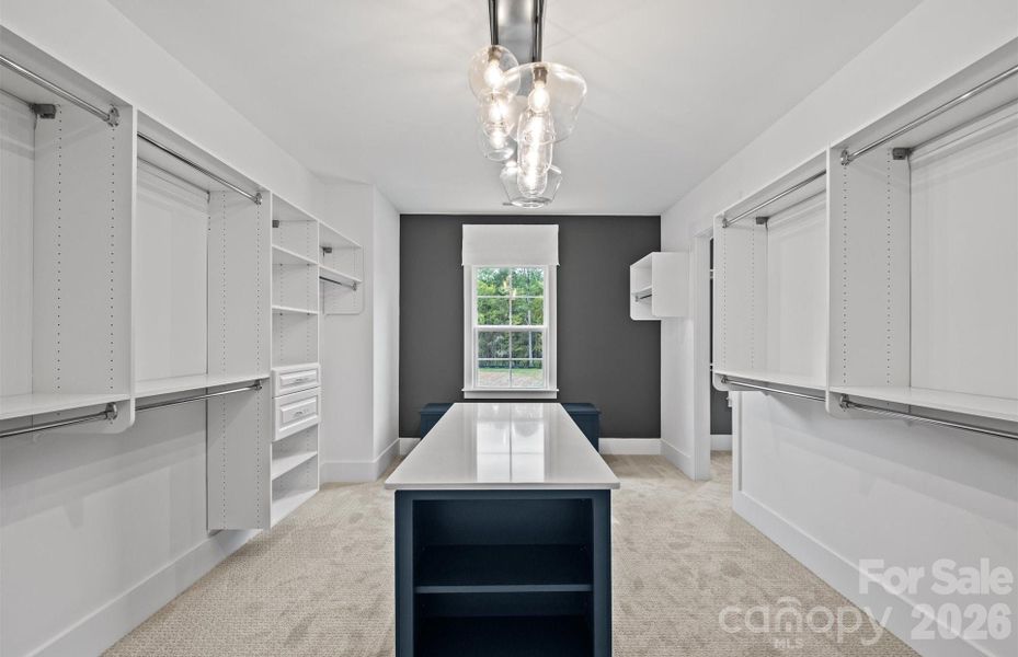 Grand Closet with Island, Window Seat and Custom Shelving. Representative Photo Grand Closet with Island, Window Seat and Custom Shelving. Representative Photo