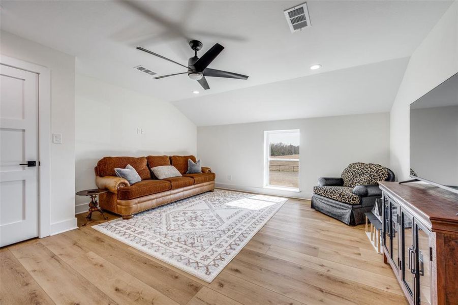 Second story bonus room serves as a second living area with lofted ceiling and closet.