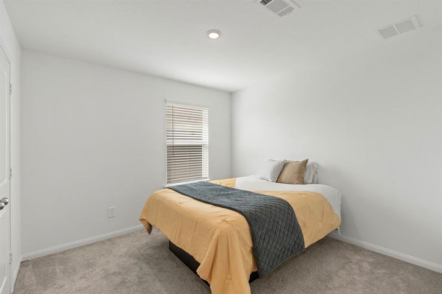 Stunning Secondary bedroom on featuring plush carpet, neutral finishes and easy access to the Flex Space and bathroom.