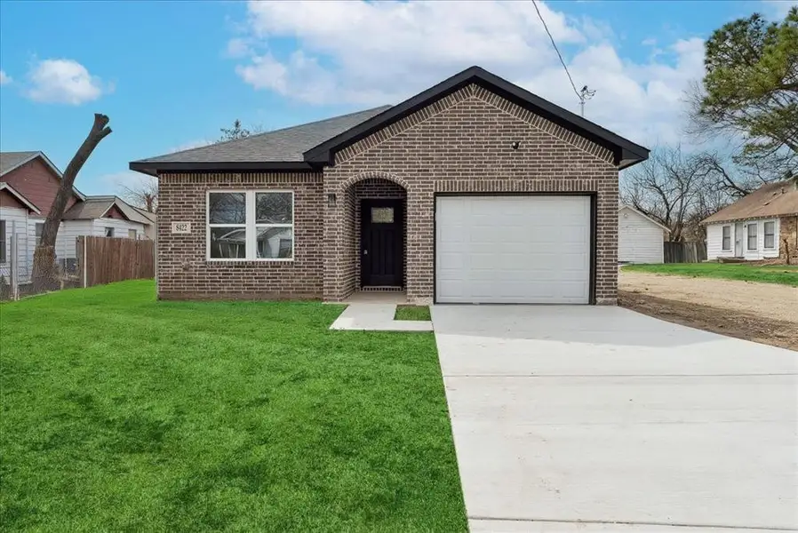 Ranch-style house featuring a garage, brick siding, fence, driveway, and a front yard