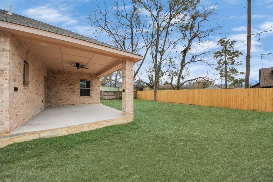 large backyard and covered patio with connections ready to build your own outside kitchen