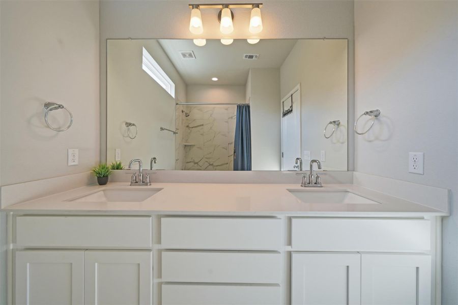 Double sinks in upstairs bathroom and tons of cabinet space
