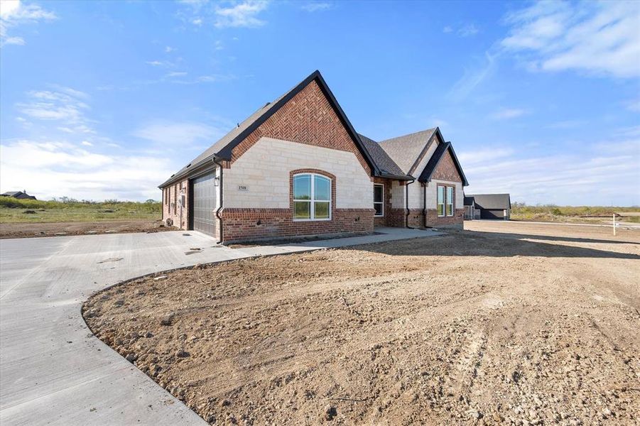 View of side of property with a garage