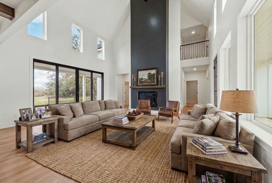 The expansive vaulted ceilings and abundant windows create a sense of openness, filling the living space with light and enhancing the overall sense of volume.