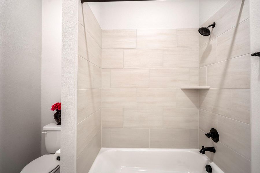Tile lined shower/tub combo in bathroom #3.