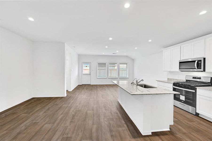 The living area features a modern open-concept layout with abundant natural light, creating a comfortable and inviting atmosphere—perfect for both cooking and relaxing while watching TV.