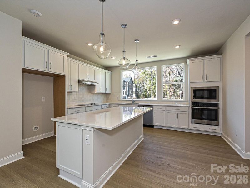 Gourmet Kitchen with White Quartz Countertops and Cabinets Gourmet Kitchen with White Quartz Countertops and Cabinets