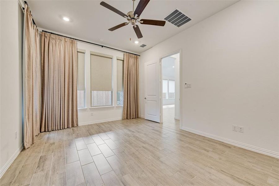 Spare room with a ceiling fan, light wood-style flooring, and recessed lighting Spare room with a ceiling fan, light wood-style flooring, and recessed lighting