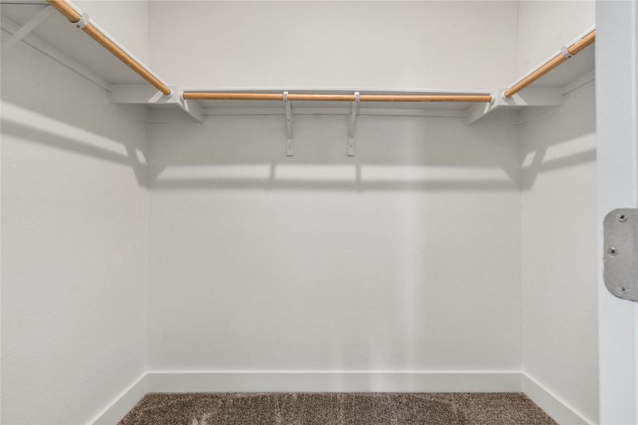 Ample hanging space and shelving offer convenient organization in this well-appointed closet.