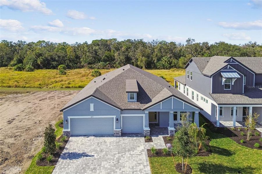 Front exterior of a new home in Creeks Edge at Twin Rivers, Parrish, FL, highlighting curb appeal (Image 28). Front exterior of a new home in Creeks Edge at Twin Rivers, Parrish, FL, highlighting curb appeal (Image 28).