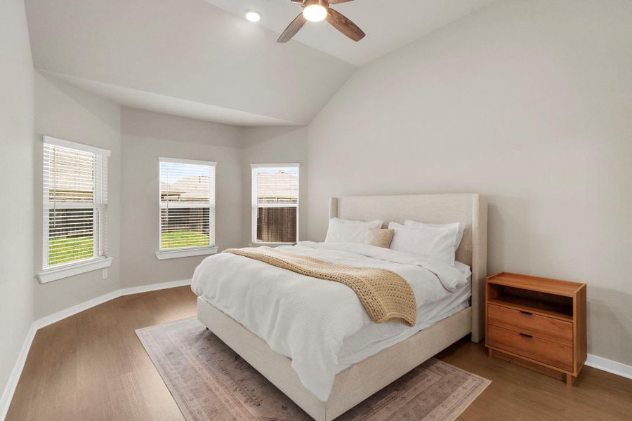 Primary bedroom with bay windows