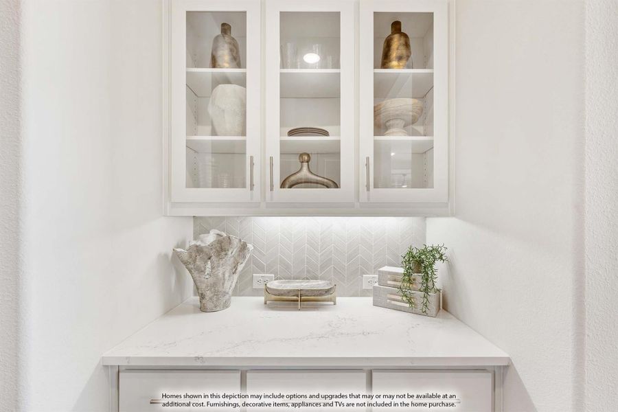 Built-in bar or butler's pantry with glass-front white cabinets, quartz countertop, and herringbone tile backsplash Built-in bar or butler's pantry with glass-front white cabinets, quartz countertop, and herringbone tile backsplash