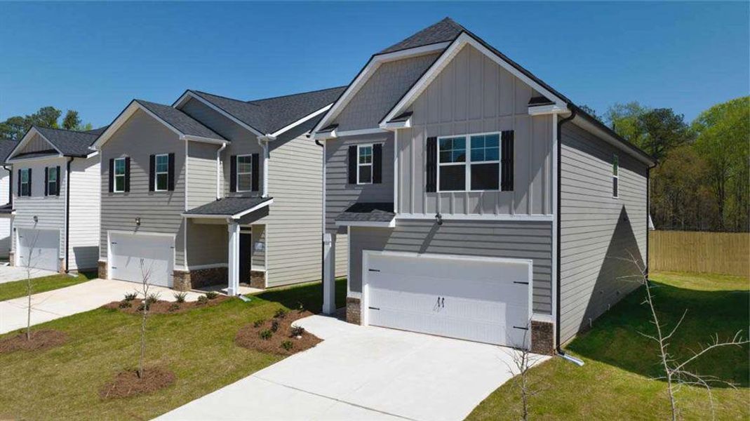 Front exterior of a new home in Shoal Creek, Hampton, GA, highlighting curb appeal (Image 22). Front exterior of a new home in Shoal Creek, Hampton, GA, highlighting curb appeal (Image 22).