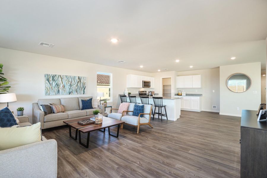 A large living room with a wood floor. A large living room with a wood floor.