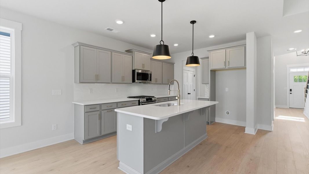 First-rate kitchen with functional layout, designer pendant lighting, and a large center island at Foxbank