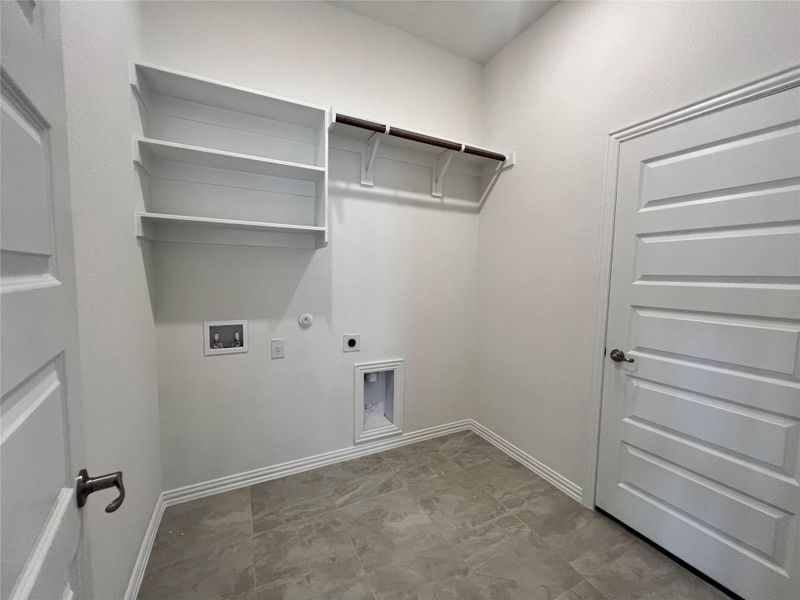 Laundry room featuring gas dryer hookup, washer hookup, and hookup for an electric dryer Laundry room featuring gas dryer hookup, washer hookup, and hookup for an electric dryer