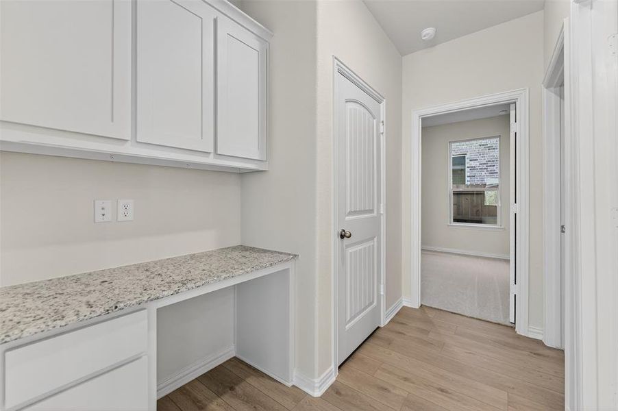 Hall with light wood-style flooring and baseboards