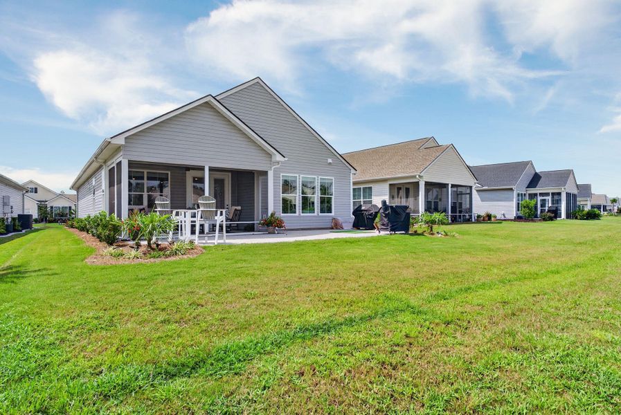 Exterior details and patio area of a home in K. Hovnanian's® Four Seasons at Lakes of Cane Bay, Summerville (Image 27).