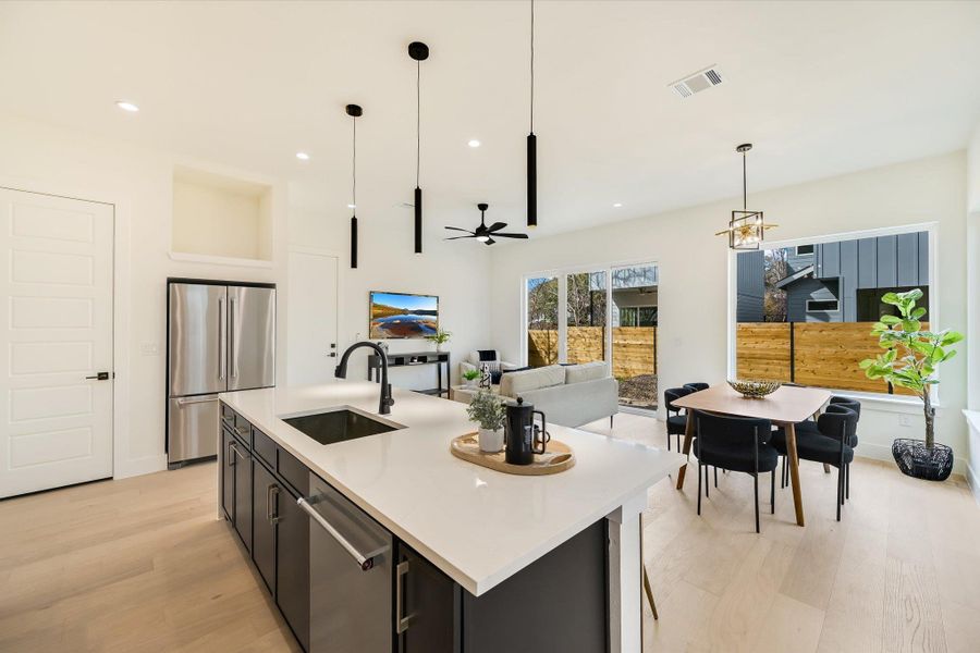 High-end stainless steel appliances are tucked into a clean design that keeps the home feeling airy and uncluttered.