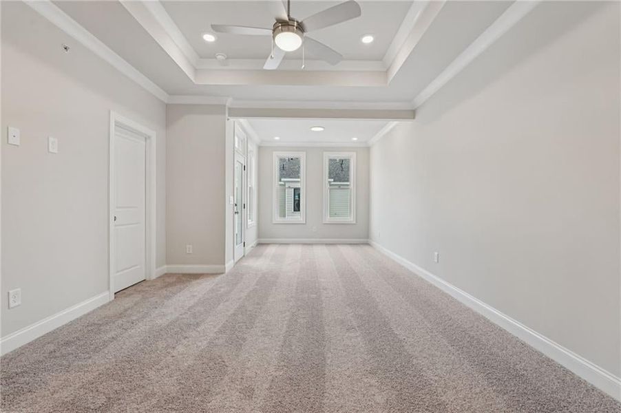 Empty room featuring light carpet, ornamental molding, recessed lighting, and a ceiling fan