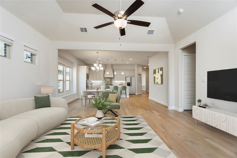 Living room with light wood-type flooring, a chandelier, a ceiling fan, and recessed lighting