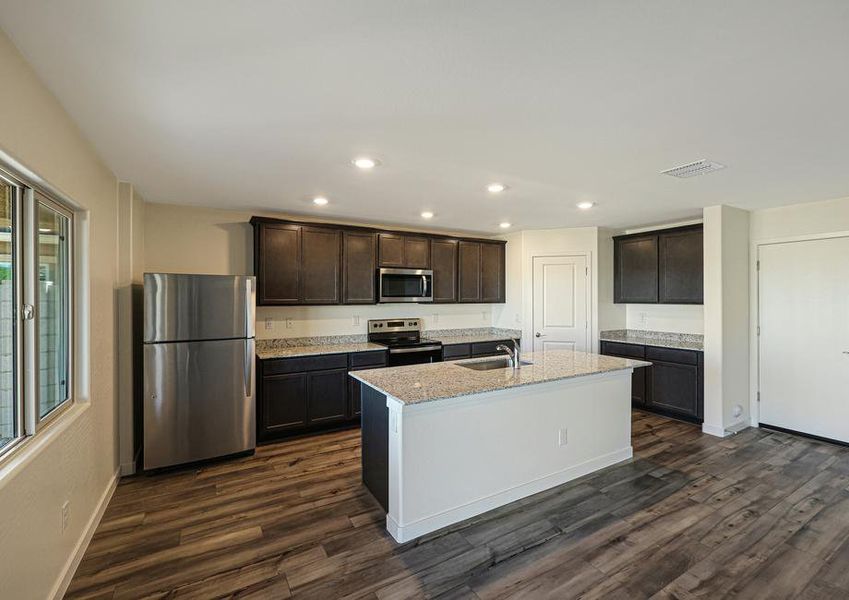 Enjoy stunning granite countertops and designer wood cabinetry in this kitchen.