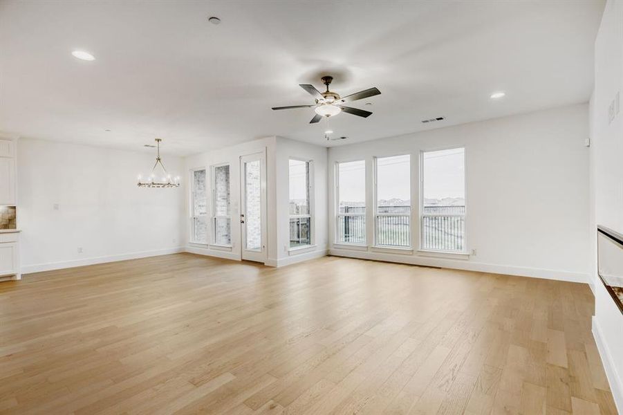 Spacious interior featuring light wood-finish flooring, recessed lighting, and a contemporary ceiling fan