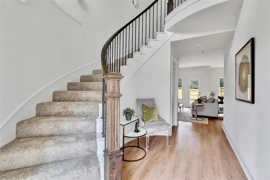 Elegant spiral staircase with custom sconces, adding charm and sophistication to your home.