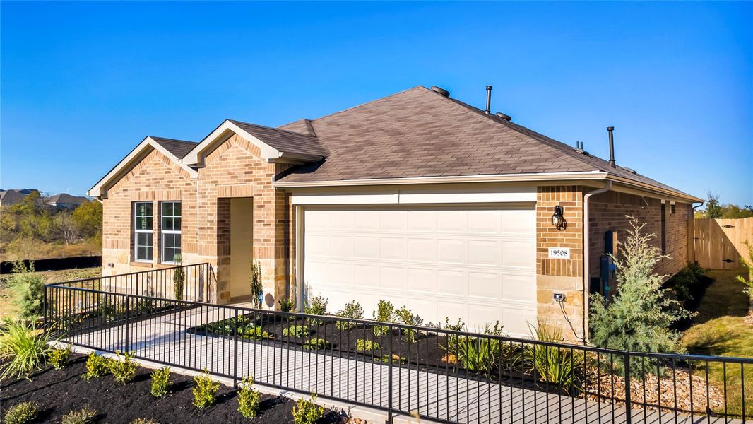 Front exterior of a new home in Carillon, Manor, TX, highlighting curb appeal (Image 20). Front exterior of a new home in Carillon, Manor, TX, highlighting curb appeal (Image 20).