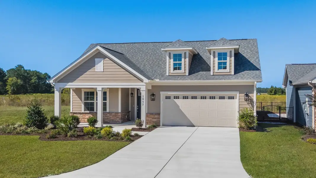 Front exterior of a new home in Courtyards by Carrell, Ocean Isle Beach, NC, highlighting curb appeal (Image 1). Front exterior of a new home in Courtyards by Carrell, Ocean Isle Beach, NC, highlighting curb appeal (Image 1).