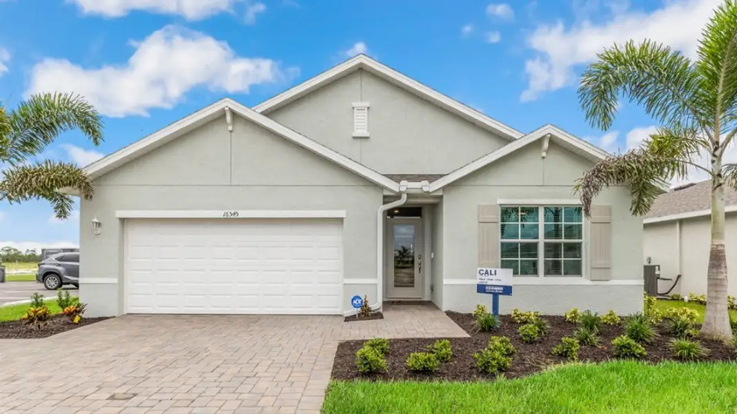 Front exterior of a new home in Coral Bay - Express & Tradition, North Fort Myers, FL, highlighting curb appeal (Image 1). Front exterior of a new home in Coral Bay - Express & Tradition, North Fort Myers, FL, highlighting curb appeal (Image 1).