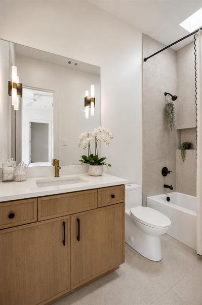Ensuite bathroom to front left bedroom, complete with tub, additional closet, and natural skylight.
