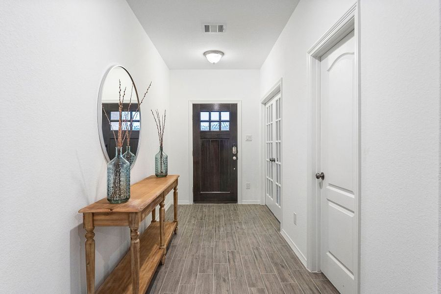 A room with a table and a mirror. A room with a table and a mirror.