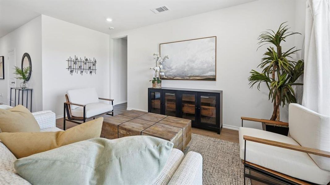 Living room featuring wood finished floors and recessed lighting Living room featuring wood finished floors and recessed lighting