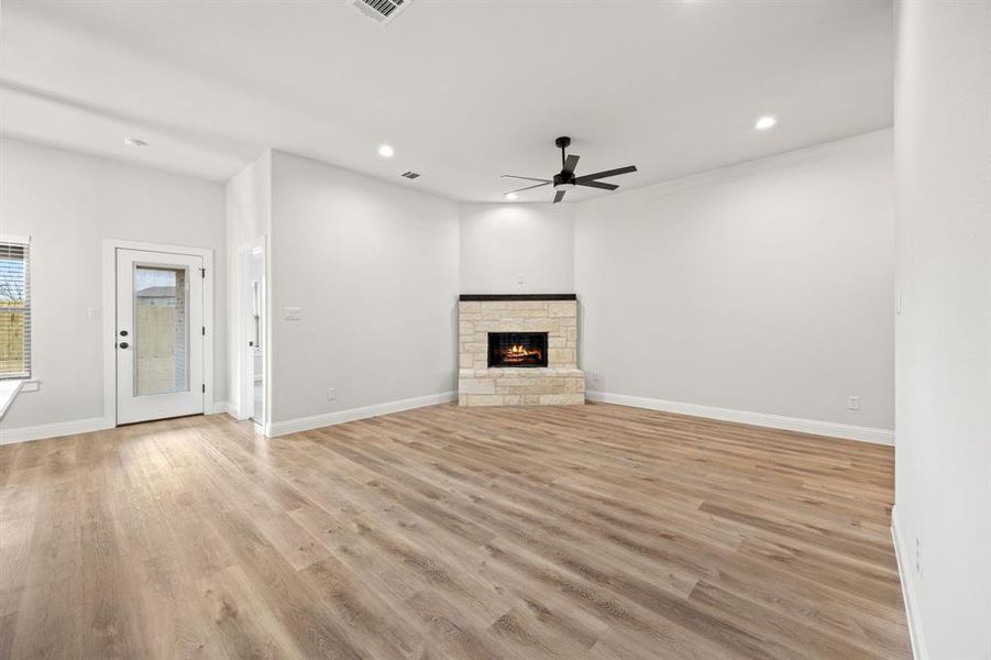 Unfurnished living room with light wood-style floors, a fireplace, recessed lighting, and a ceiling fan