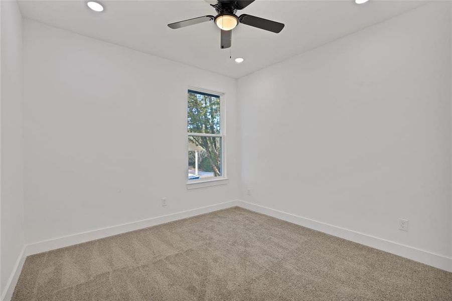 Bedroom with ceiling fan.